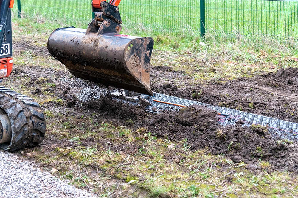 Excavator clearing walkway route